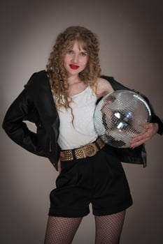 Sensuality woman holding mirror disco ball, looking at camera during celebration party in nightclub photo