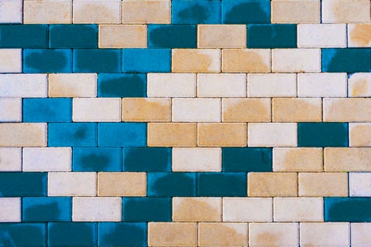 Multicolor beige and blue stone tile as background, texture photo