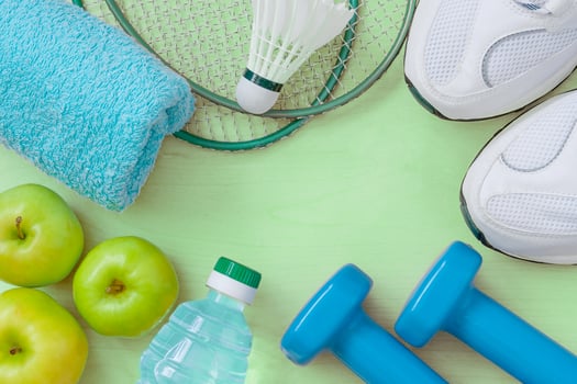 Attributes of a healthy lifestyle food, sports or athlete equipment on bright background photo