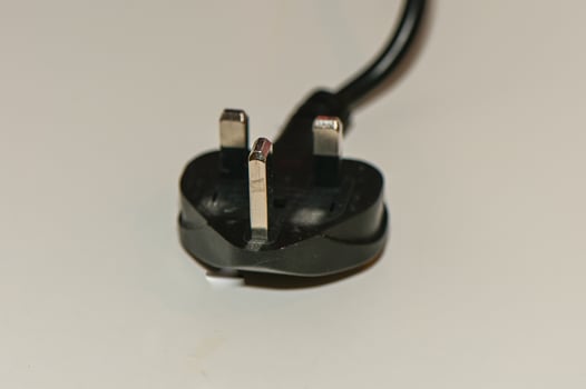 black plug from English standard socket on the table 1 photo
