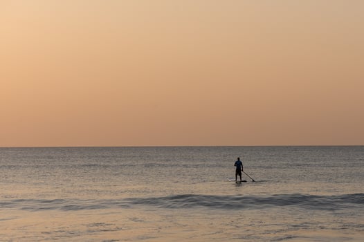 SUP boarding lesson on the Mediterranean sea in winter at sunset 1 photo