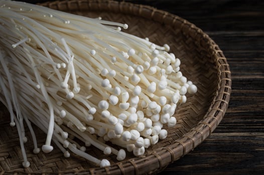 a basket filled with Golden Needle Mushroom Enoki Mushroom photo