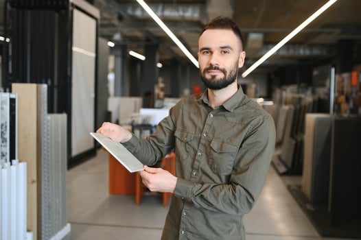 buyer examines ceramic tiles in a construction store photo