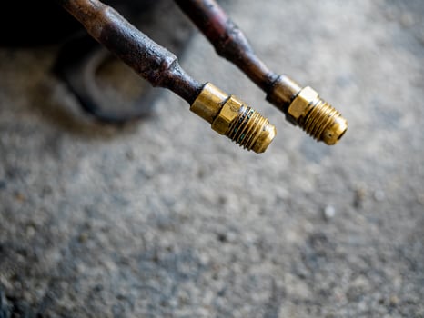 Air Conditioner Charging Hose on the rough concrete flooring photo