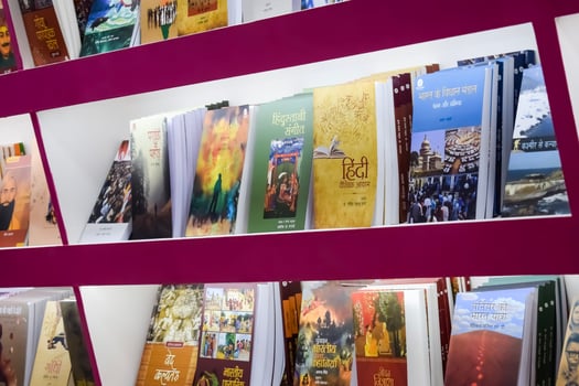 New Delhi, India, February 17 2024 - Variety of Books on shelf inside a book-stall at Delhi International Book Fair, Selection of books on display in Annual Book Fair at Bharat Mandapam complex photo
