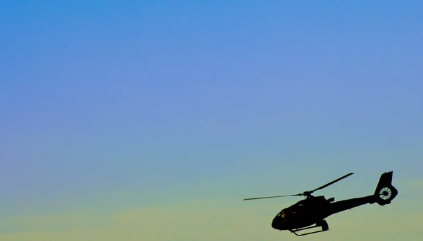 Helicopter flying over the river photo