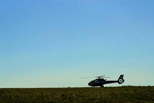 Helicopter flying over the river photo