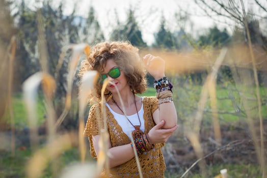 Fashion shot of a beautiful boho style girl on nature background. Boho, hippie photo