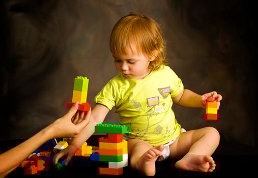 Small girl plays with the designer photo