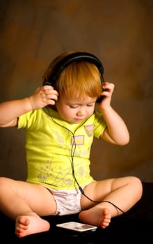 Small girl listens to the music photo