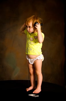 Small girl listens to the music photo
