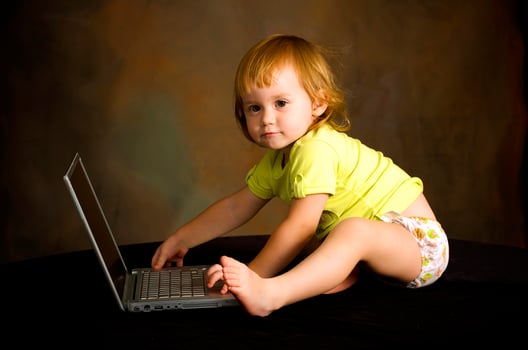 Small girl works with the computer photo