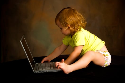 Small girl works with the computer photo