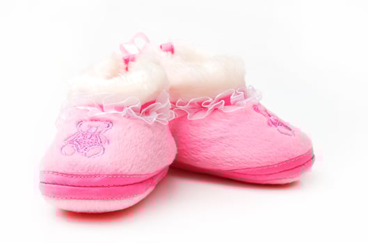 Pair of baby's slippers hanging on a rope. Including copy space photo