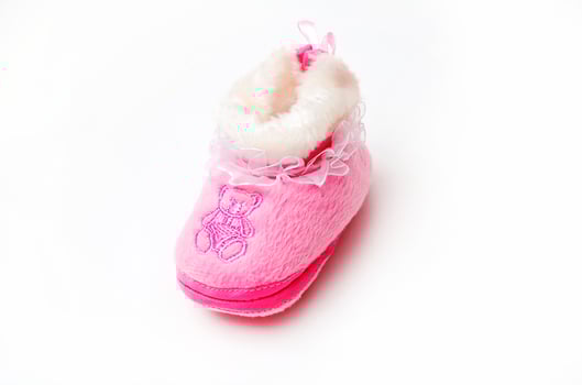 Pair of baby's slippers hanging on a rope. Including copy space photo