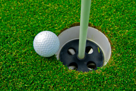 Game in the golf club against the background of the green juicy grass photo