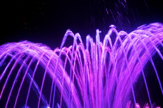 Coloured water fountain at night photo