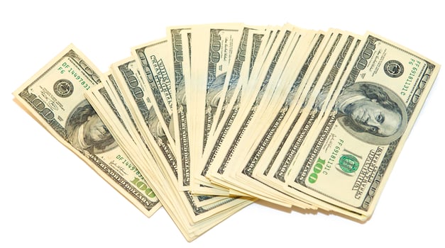 American dollars arranged in stacks of 100 bills each photo