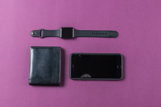 Business concept. Top view of dollars, watch, smartphone on color background photo