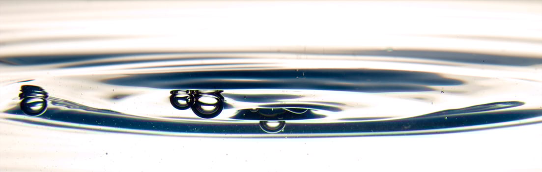 The round transparent drop of water, falls downwards photo