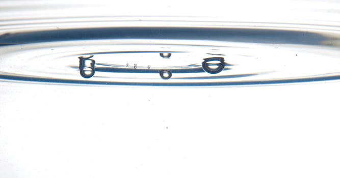 The round transparent drop of water, falls downwards photo