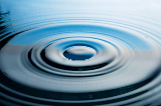 The round transparent drop of water, falls downwards photo