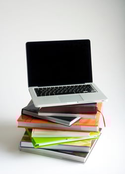 Stack of book and laptop photo