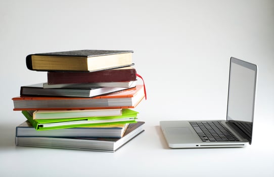 Stack of book and laptop photo