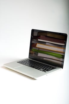 Stack of book and laptop photo