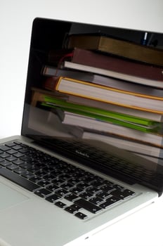 Stack of book and laptop photo