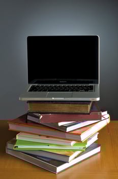 Stack of book and laptop photo