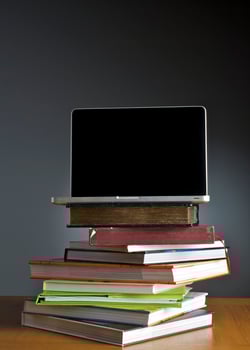 Stack of book and laptop photo