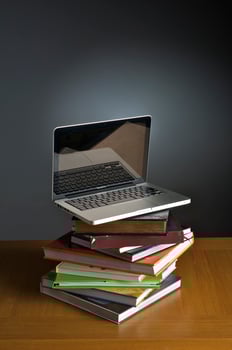 Stack of book and laptop photo