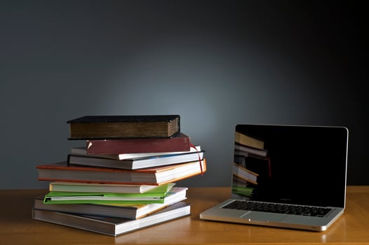 Stack of book and laptop photo