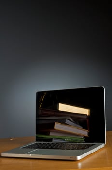 Stack of book and laptop photo