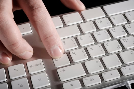 The man's hand works with the keyboard photo