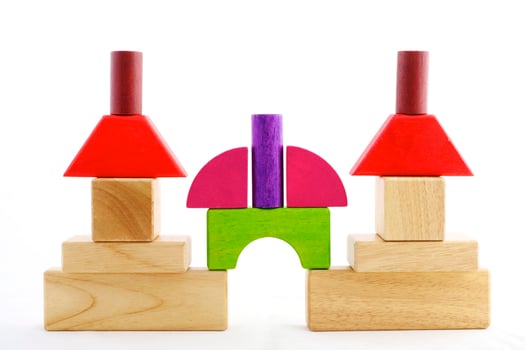Wooden toy blocks on white background photo