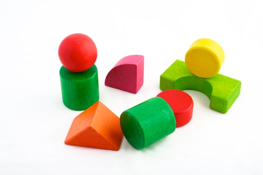 Wooden toy blocks on white background photo