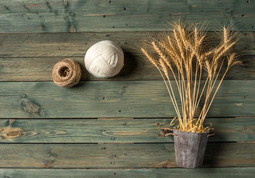 Wheat Ears on the Wooden Table. Sheaf of Wheat over Wood Background. Harvest concept. photo