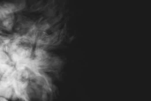 White smoke isolated on black background photo