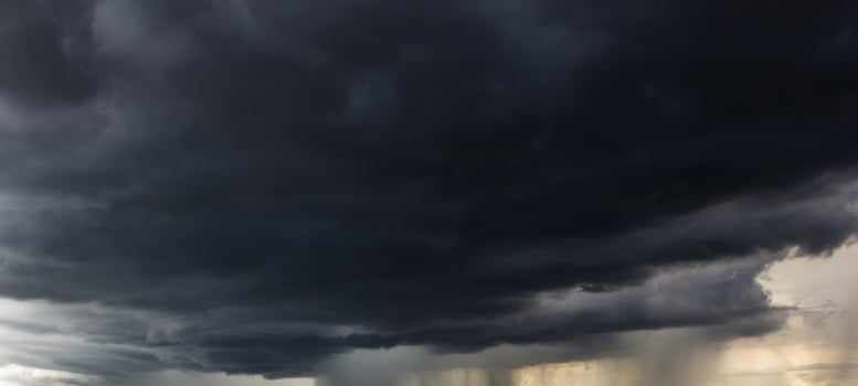 The dark sky with heavy clouds converging and a violent storm before the rain.Bad or moody weather sky and environment. carbon dioxide emissions, greenhouse effect, global warming, climate change photo