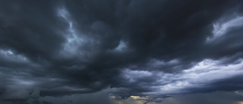 The dark sky with heavy clouds converging and a violent storm before the rain.Bad or moody weather sky and environment. carbon dioxide emissions, greenhouse effect, global warming, climate change photo