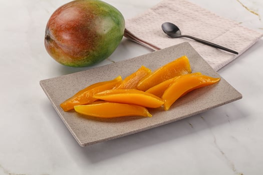 Canned mango slices in the bowl photo