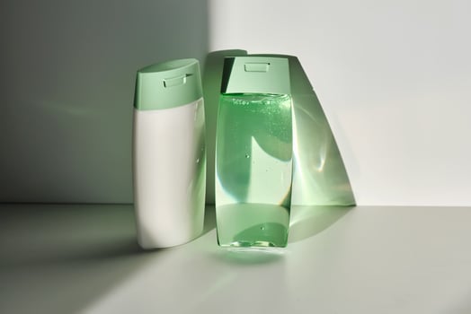 Shampoo and hair conditioner on a white background with sun light. photo