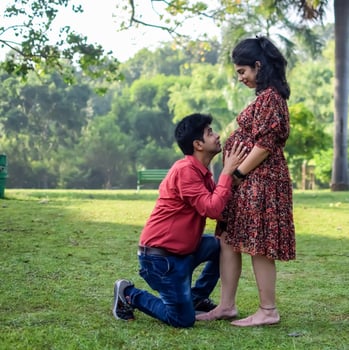 Indian couple posing for Maternity shoot pose for welcoming new born baby in Lodhi Garden in Delhi India, Maternity photo shoot done by parents for welcoming their child, Pre Baby Photo Shoot