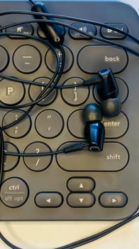 Earphone and keyboard in office business work photo