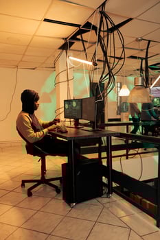 Encryption specialist using computer malware and virus to hack government network late at night, planning data breach to steal passwords. Hacker accessing important server and breaking system. photo