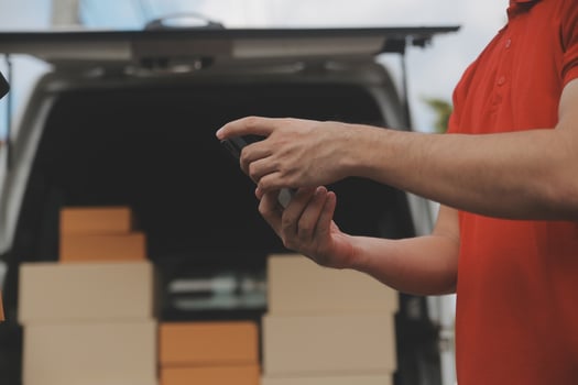 Asian delivery express courier young man use giving boxes to woman customer he wearing protective face mask at front home photo