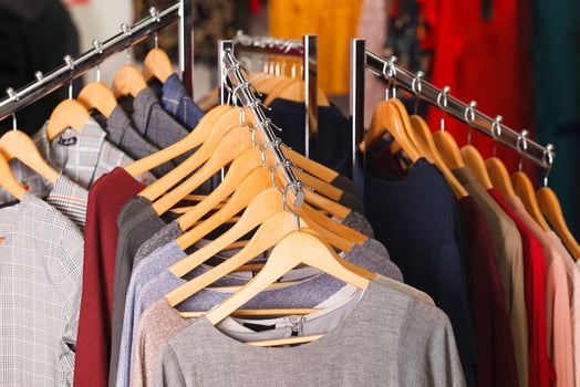 Closeup shot of clothes hang on a shelf in modern fashion store photo
