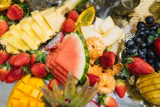 Fresh organic fruits background. Healthy eating concept. Fresh, exotic, organic fruits, light snacks in a plate on a buffet table photo